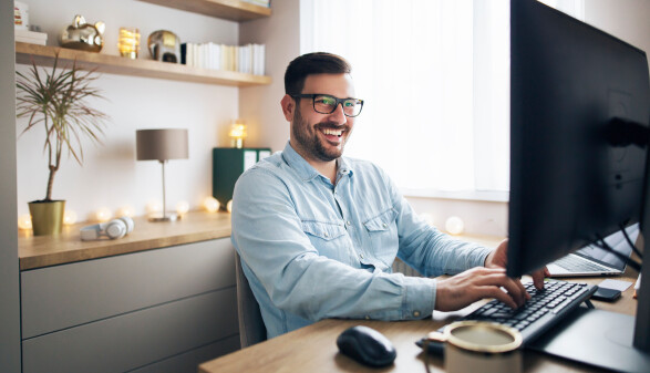 Mann macht Home Office und schaut auf den Bildschirm